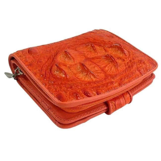 Closed zippered orange crocodilian hornback wallet at three-quarter angle showing glossy raised scales and zipper closure detail