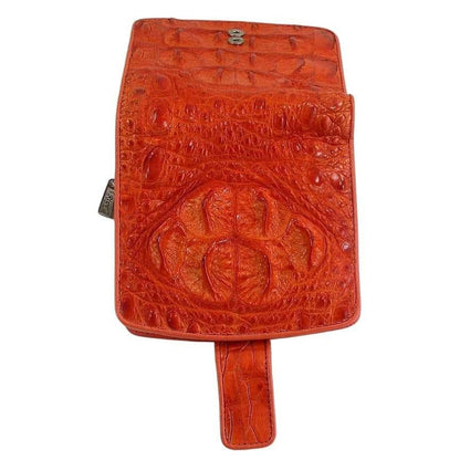 Back flap view of orange crocodilian wallet displaying prominent hornback crown scales with deep papaya-amber texture and snap tab strap