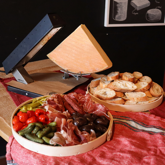 image of raclette kit that includes cheese, meat, pickles and bread