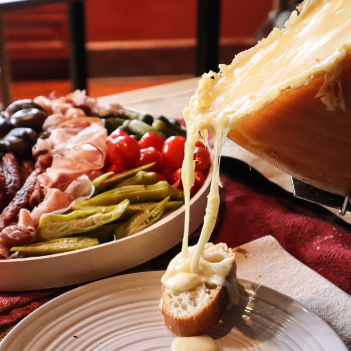 Image of raclette melting onto a piece of bread