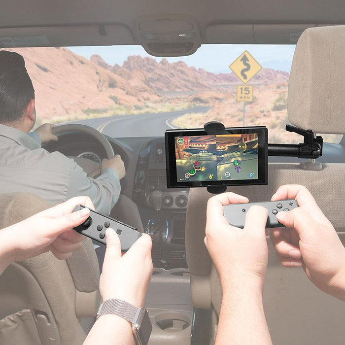Two passengers enjoy a Nintendo Switch secured on the RoadVise® Phone Holder with Car Headrest Mount while traveling through winding desert roads.