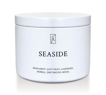 White tin candle container labeled 'Seaside' with a brand logo on a white background