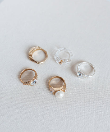 A collection of Berlin-made jewelry, featuring Shining Star Crystal Rings, displayed on a white surface.
