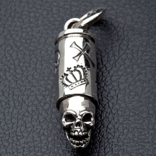 A solid sterling silver skull bullet pendant with detailed and intricate crown and cross engravings.