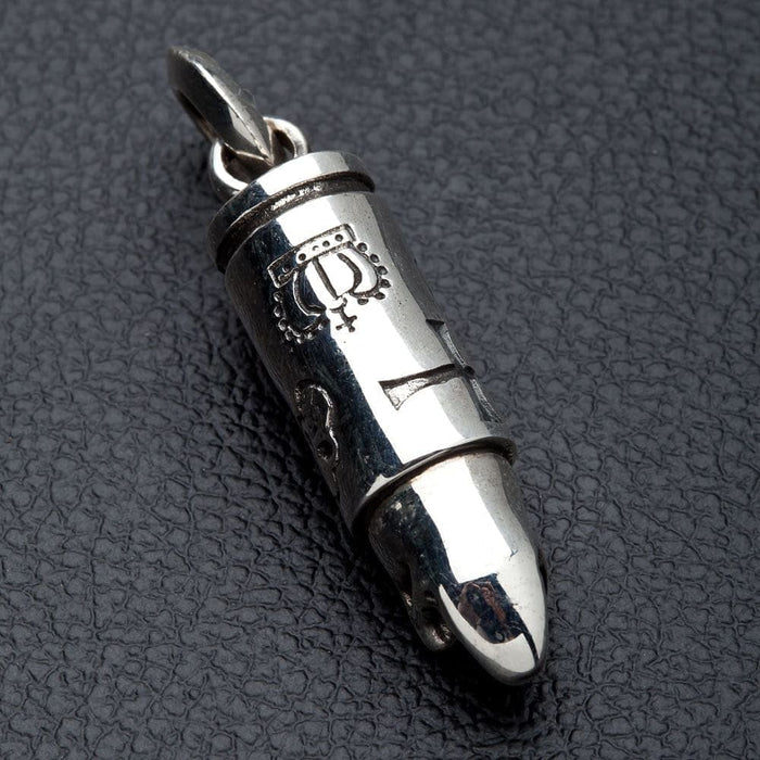 A 925 sterling silver bullet pendant with a detailed skull, handcrafted with a brilliant high-polish shine.