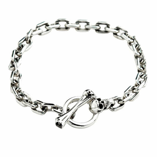 Top view of the skull T-bar sterling silver bracelet with chain laid in a circle.