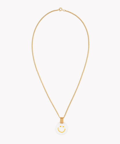 The Smilie Dude Medaillon Gold Necklace by WALD Berlin is an 18k gold-plated chain piece, showcasing a precisely crafted white circular medallion adorned with a yellow smiley face, made in Germany.
