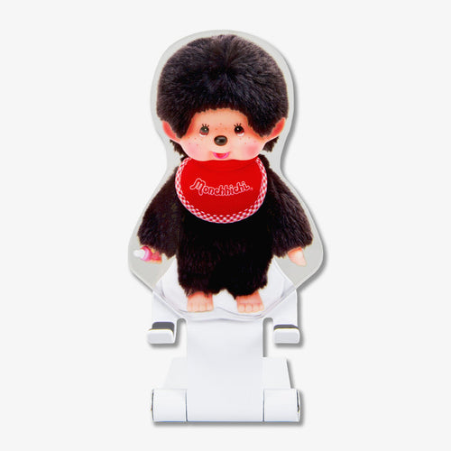 Front view of Monchhichi Boy character phone stand showing plush figure with red Monchhichi bib on a white adjustable stand