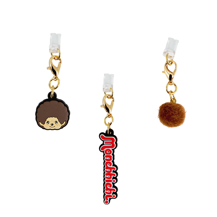 Front close-up of Monchhichi charging port charms 3-pack showing gold clasps, character face and brown pom pom on white