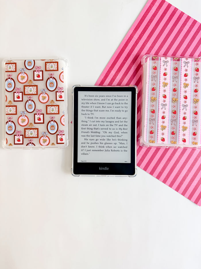 Kindle device with decorative cases on a white background