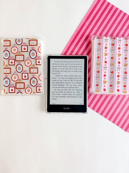 Kindle device with decorative cases on a white background