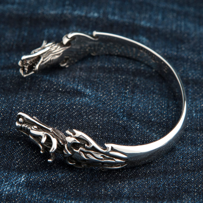 The open, adjustable cuff design of the sterling silver dragon bracelet.