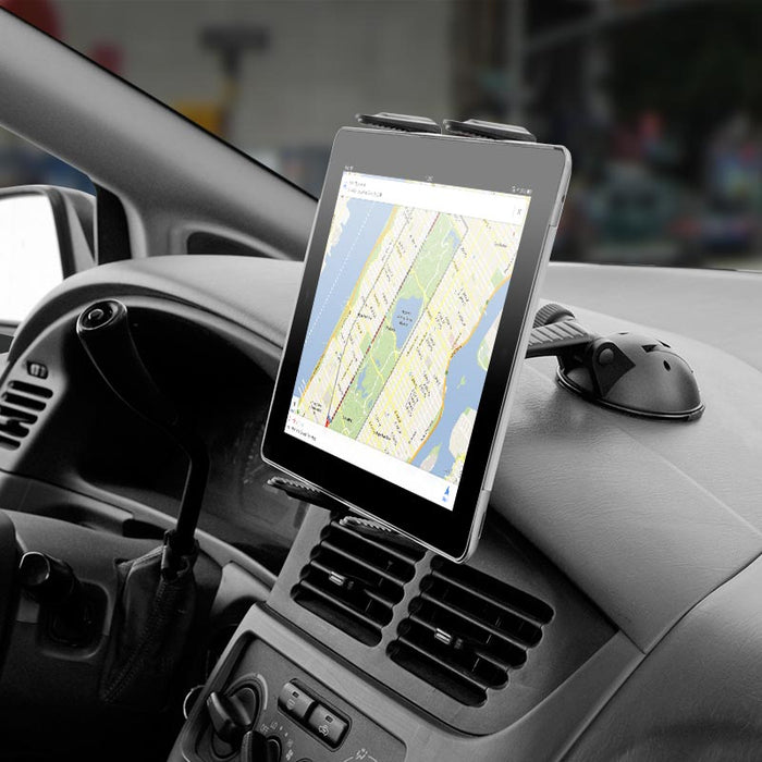 An iPad displaying a New York City map is mounted on a car dashboard with the Sticky Suction Windshield or Dash Slim-Grip® Tablet Mount, securely positioned for drivers to view navigation easily while on the go.