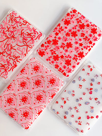 Four transparent plastic sheets with red floral patterns on a white background