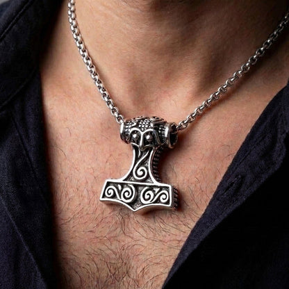 Man wearing the heavy sterling silver Mjolnir pendant on a thick chain, demonstrating its scale resting on the chest.