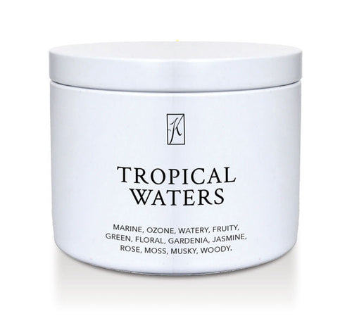 'Tropical Waters' scented candle in a tin container on a white background.